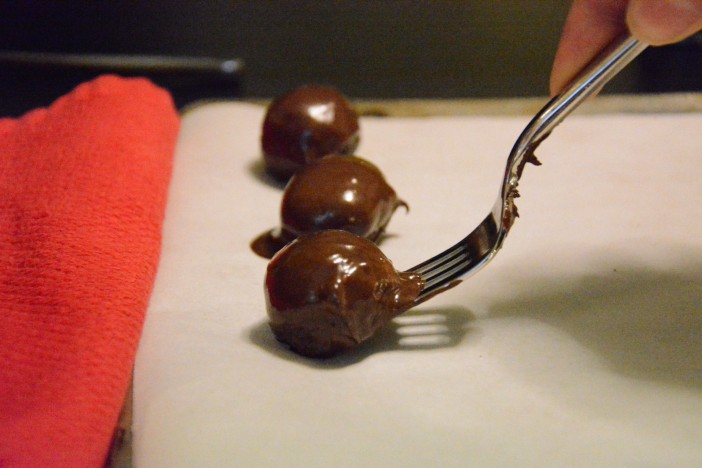 Covering truffles in chocolate