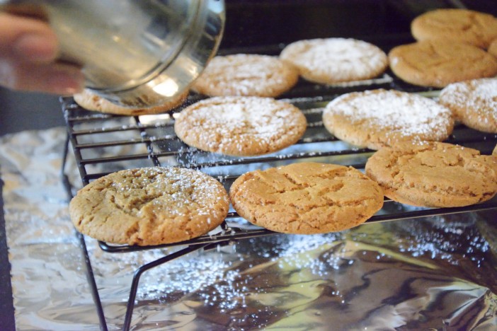 Dusting the Sugar and Spice cookies with powdered sugar
